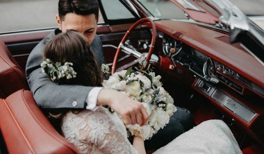 couple on wedding day sat in classic car