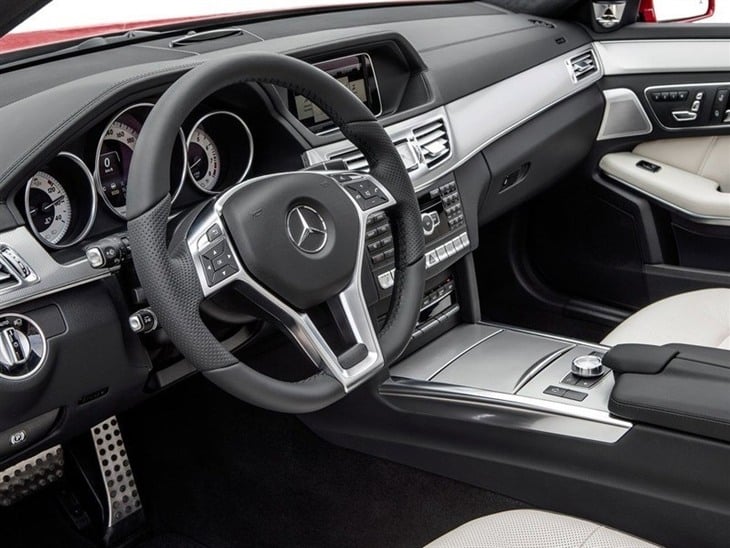 The Interior of a Mercedes Benz E Class Estate showing the Steering Wheel and Dashboard