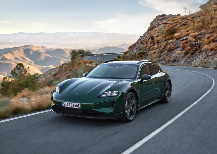 Green Porsche Taycan Cross Turismo driving on a mountain road
