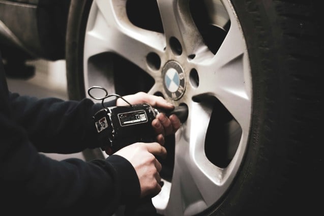 man refitting a tyre