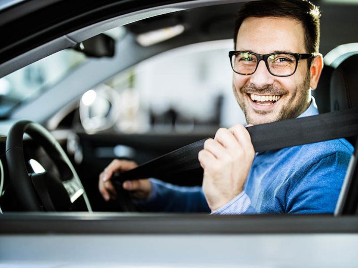 man smiling sat in car