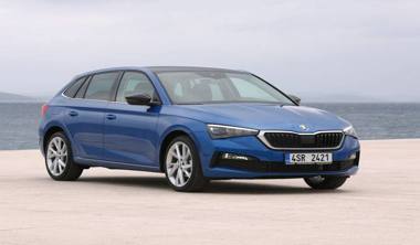 An image of the Skoda Scala, a small family car, parked on a scenic road with a sky in the background.