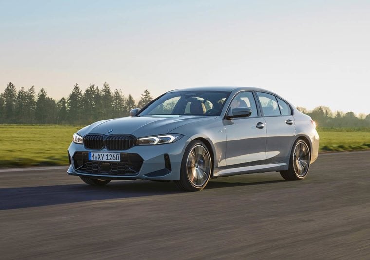 Grey BMW 3 Series driving on track