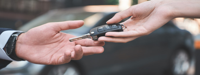 dealership passing keys to business driver