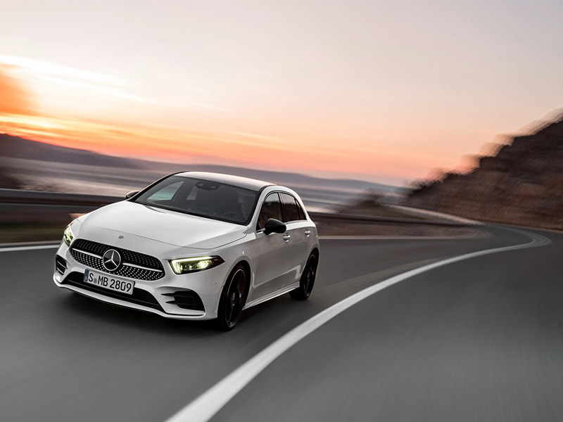 white mercedes-benz a class driving on the road