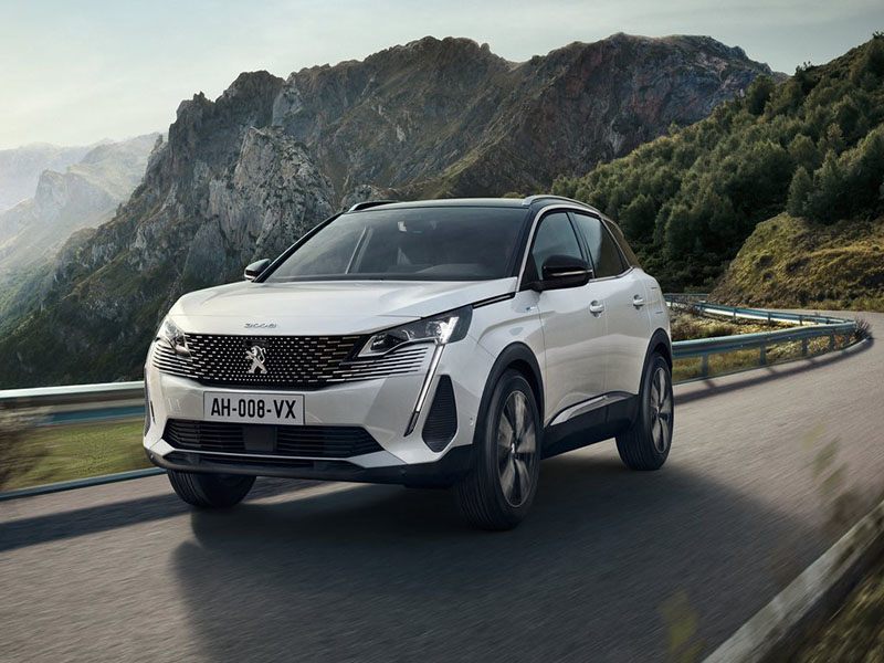 white peugeot 3008 driving on mountain road