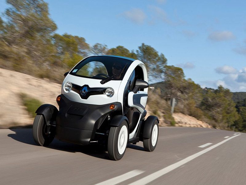 white renault twizy driving on road