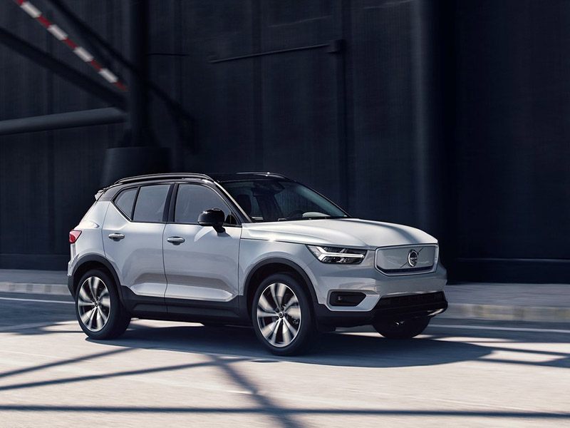white volvo xc40 recharge driving on road