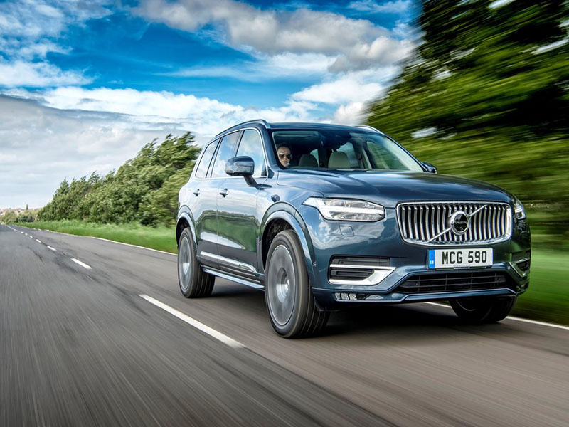 blue volvo xc90 driving on open road