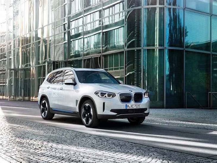 white bmw ix3 electric car driving on road