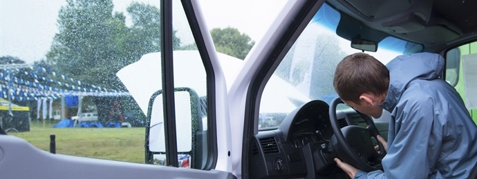 man inspecting steering wheel on van