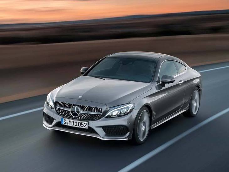 The front of A Mercedes Benz C-Class Coupe in Silver Driving