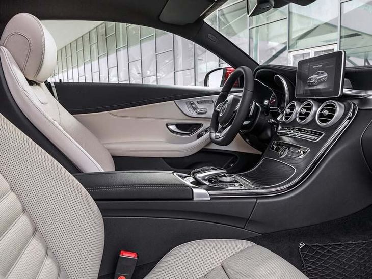 An interior view of the Drivers side seat and Steering wheel in Mercedes Benz C Class Coupe