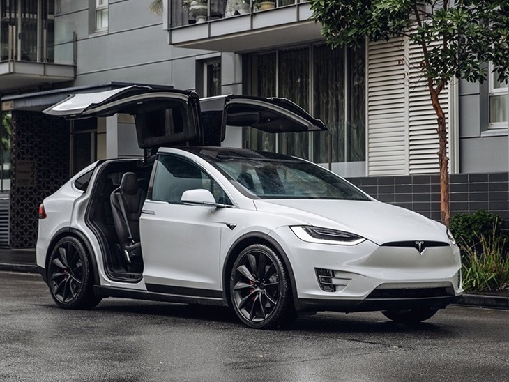 white tesla model x with doors open