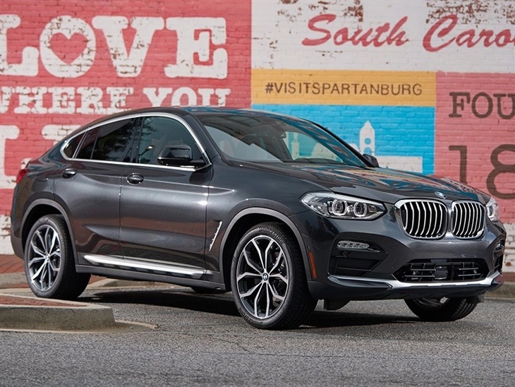 BMW X4 2019 Promo colour grey front right view on street with wall art
