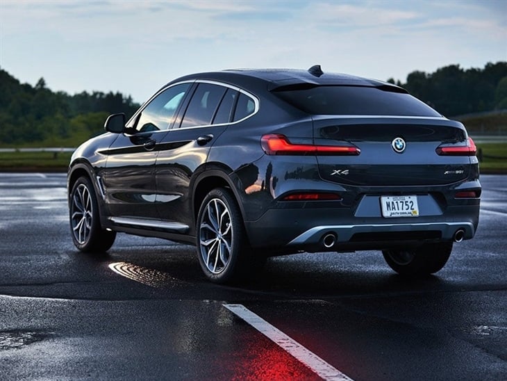 BMW X4 2019 Promo in dark metal colour rear left view sunset sunrise racetrack