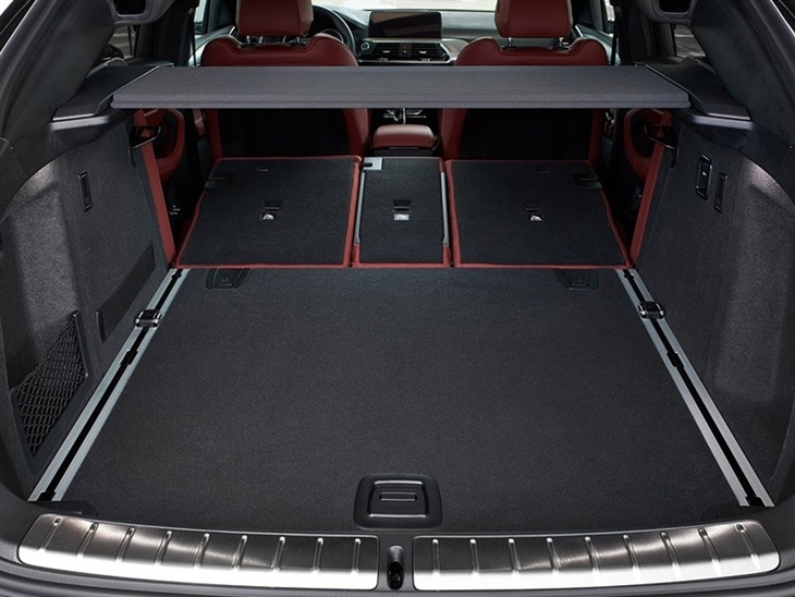BMW X4 2019 Promo interior view of boot trunk with folding seats showing available space