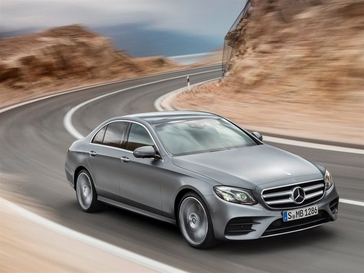 A side view of a Mercedes Benz E Class Saloon in Silver Driving