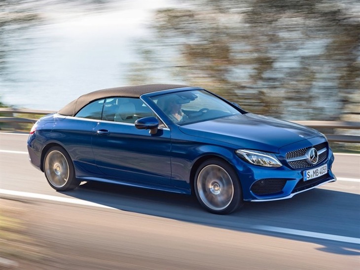 The Front side view of a Mercedes Benz C-Class Cabriolet with the Roof Up in Blue