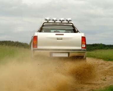 pick up truck kicking up dirt