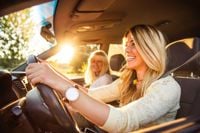young woman driving with her mother in car
