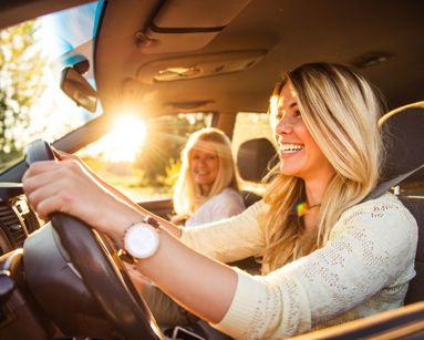 young woman driving with her mother in car