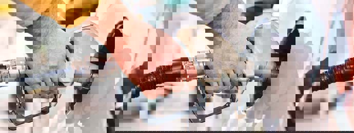 Image of a person's hand using a petrol pump
