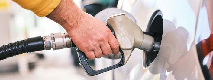 Image of a person's hand using a petrol pump