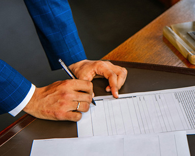 person writing on white form paper