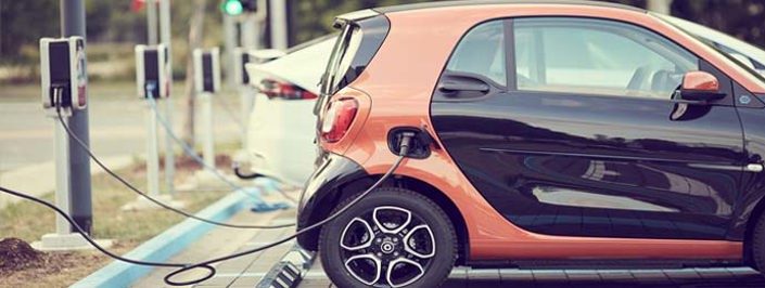 orange smart ev car charging at public charging point