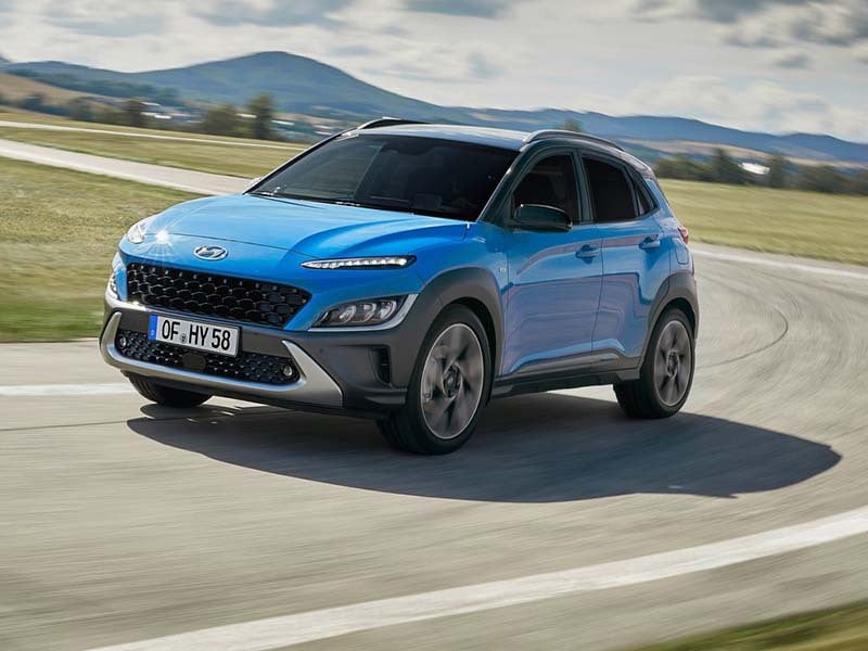 blue hyundai kona driving on a test track