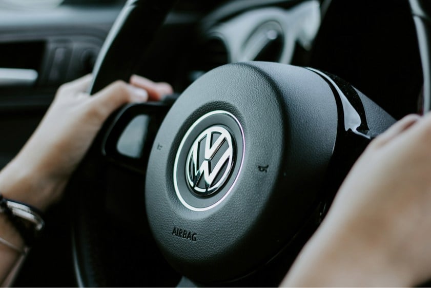 Person using a volkswagen steering wheel
