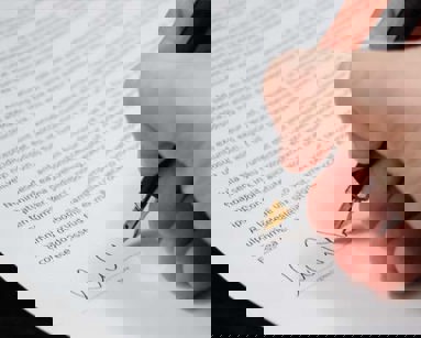 close up of person signing a document