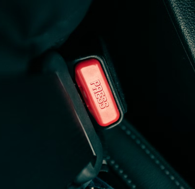 a close up of-a button on a car seat