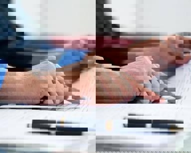 close up of hand pointing at finance documentation