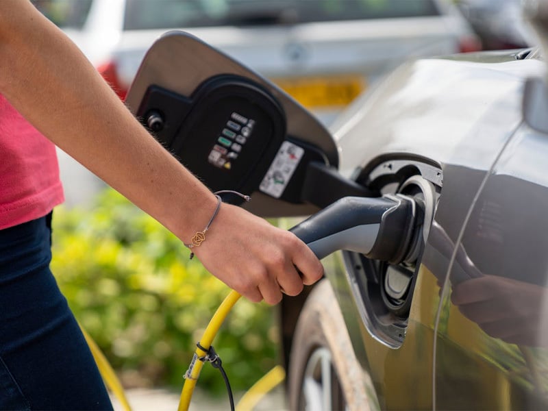 Person charging an electric car