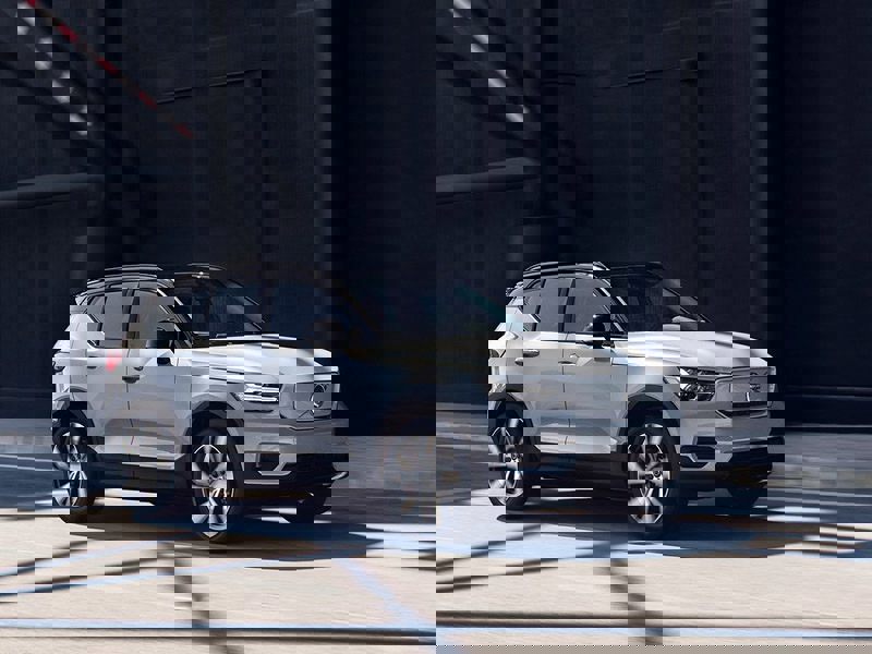 white volvo xc40 recharge driving on road