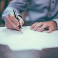man signing contract