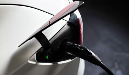an electric car plugged in to a charger