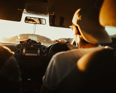 Man Holding the Steering Wheel While Driving