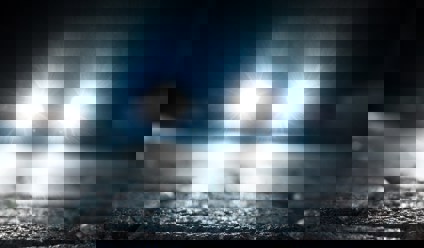 bright vehicle headlight on the street