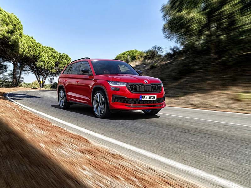 red skoda kodiaq driving on the road