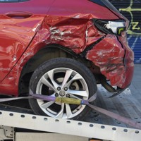 a red car on a flatbed tow truck