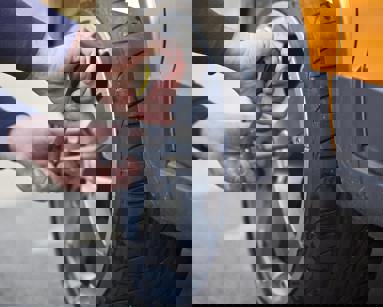 close up of man replacing car tyre