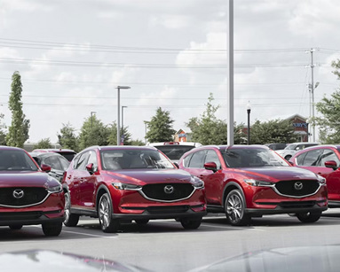 a row of cars parked in a parking lot