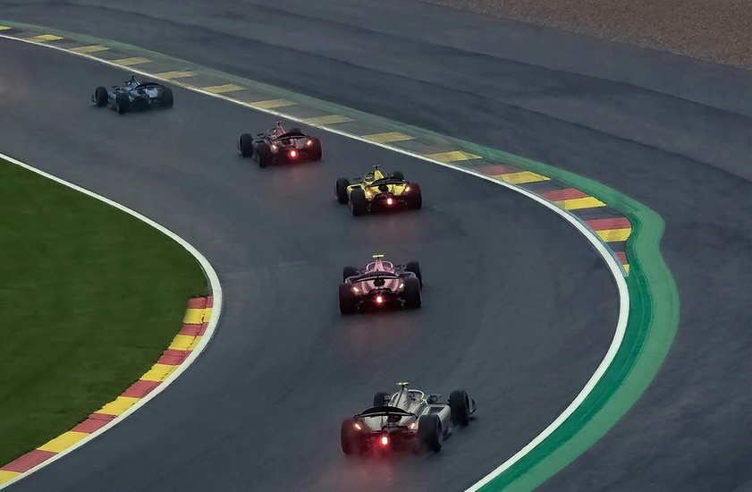 formula 1 race cars speeding around a track