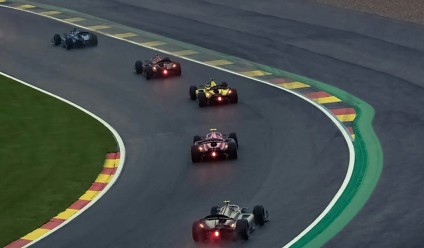 formula 1 race cars speeding around a track