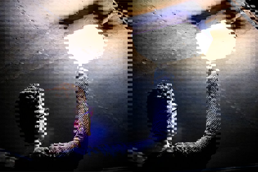 man holding lighted ceiling light