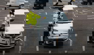 parking attendant putting fine on car