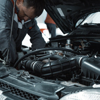 man fixing car